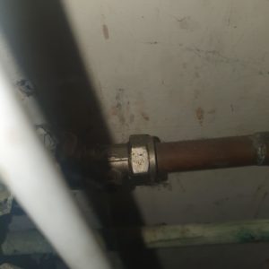 plumbing pipework behind home appliance